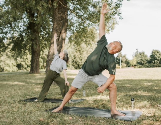 A man and a woman are exercising outdoors