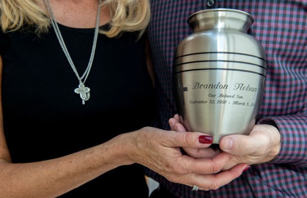 Rose and Allen Nelson hold a bag of their son Brandon's ashes at their home on Sunday, Oct. 21, 2018. Brandon died in March aged 26 after hanging himself in an unlicensed independent nursing home. Rose wears Brandon's cross. (Photo by Mindy Shaver, Orange County Register/SCNG)
