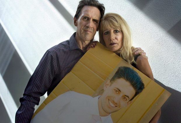 Rose and Alan Nelson of Santa Monica hold a photo of their son Brandon Nelson in 2018.