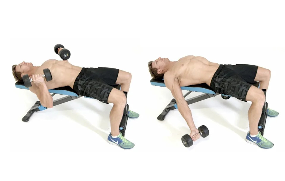Man completing bicep curls lying on a bench
