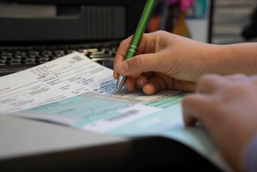 A doctor writes a prescription. 