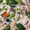 This image shows a variety of cultivated sources of protein—legumes, nuts, grains, and vegetables—photographed from above.