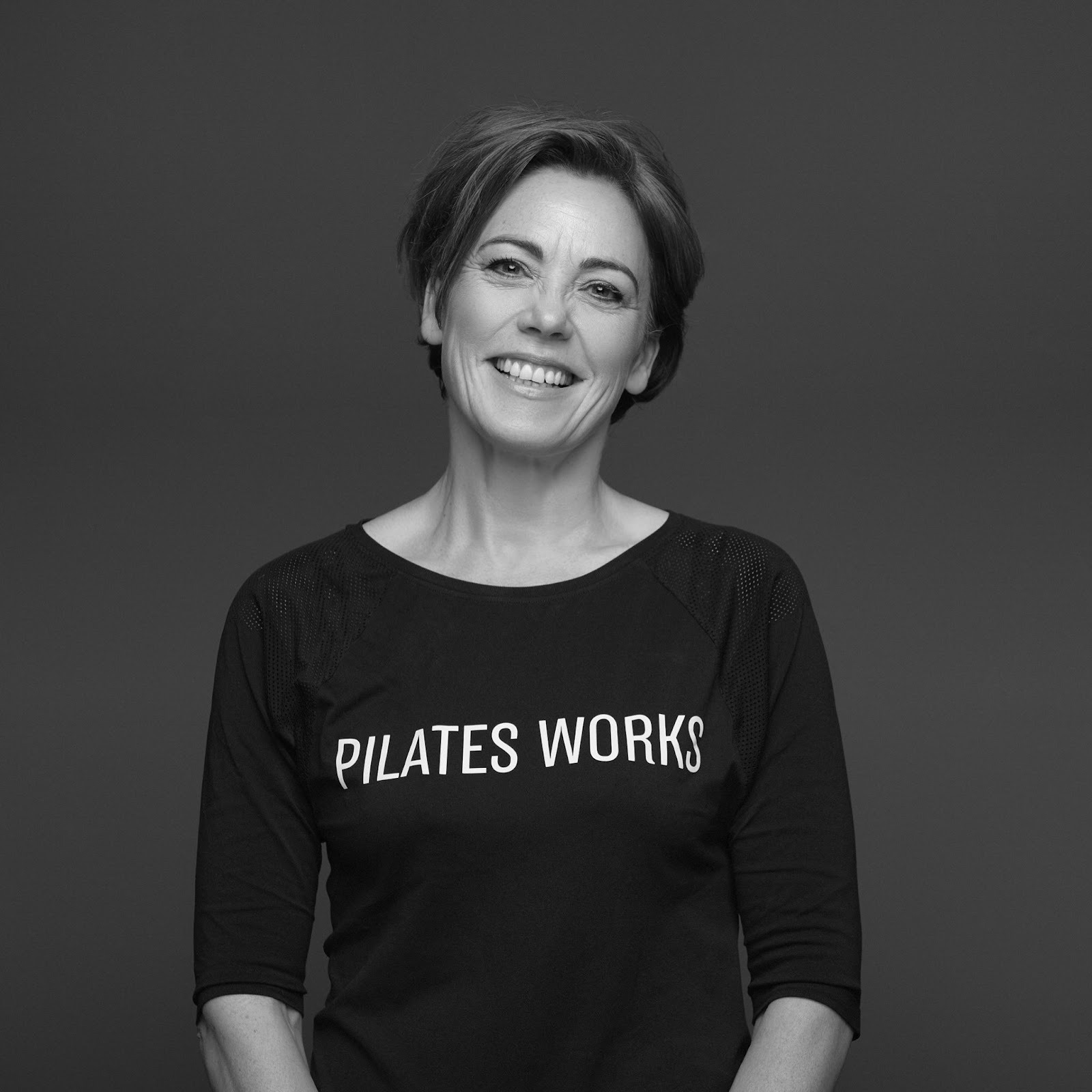 Woman, wearing a black t-shirt with white text 