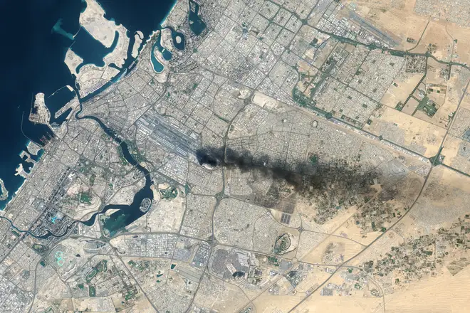 A satellite view of Dubai International Airport after a drone caught fire on a fuel tank