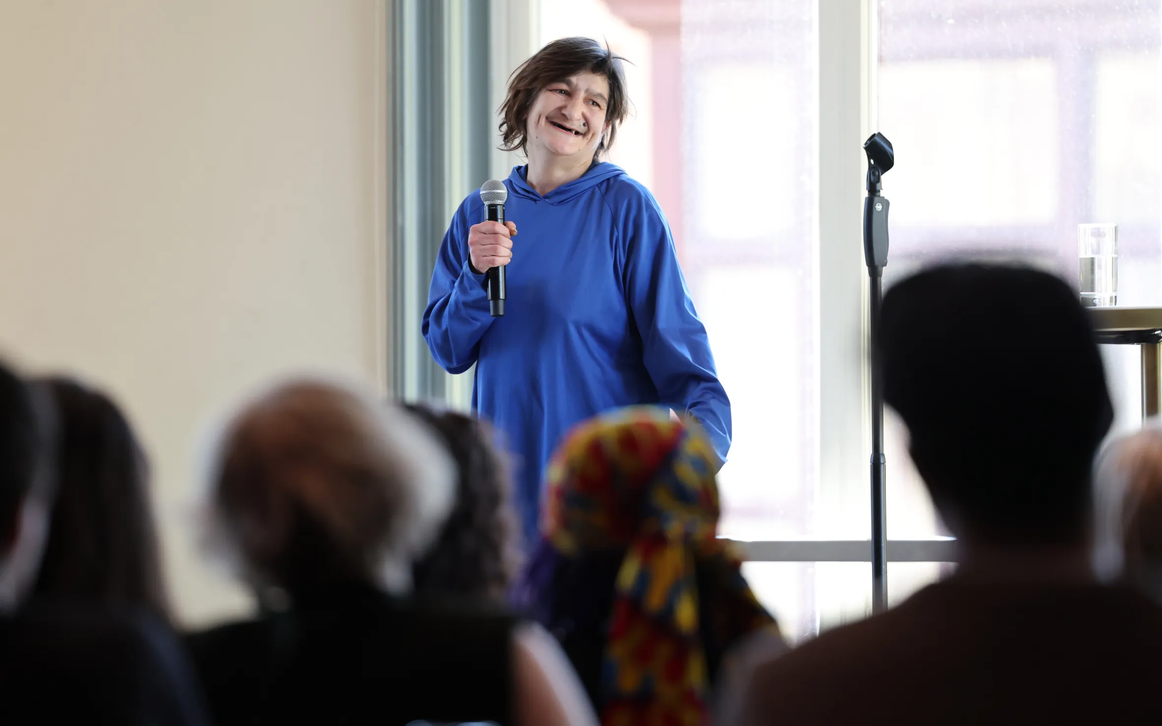 Tracy, a homeless woman, performs stand-up comedy on stage at the Royal Albert Hall.