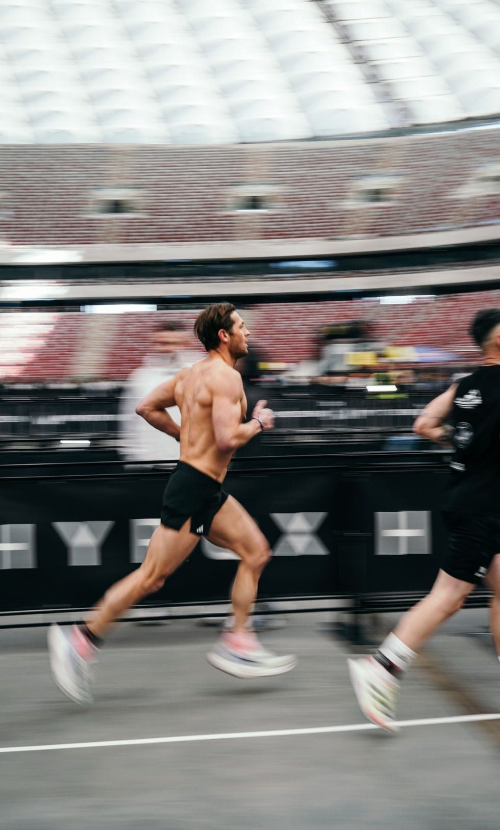 Runners compete in a race in a stadium