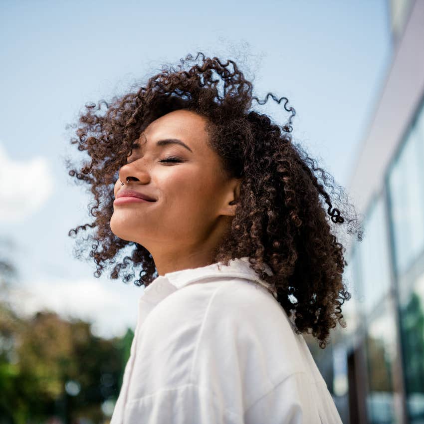 A happy woman enjoys the outdoor life