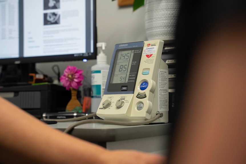 A doctor measures a patient's blood pressure.