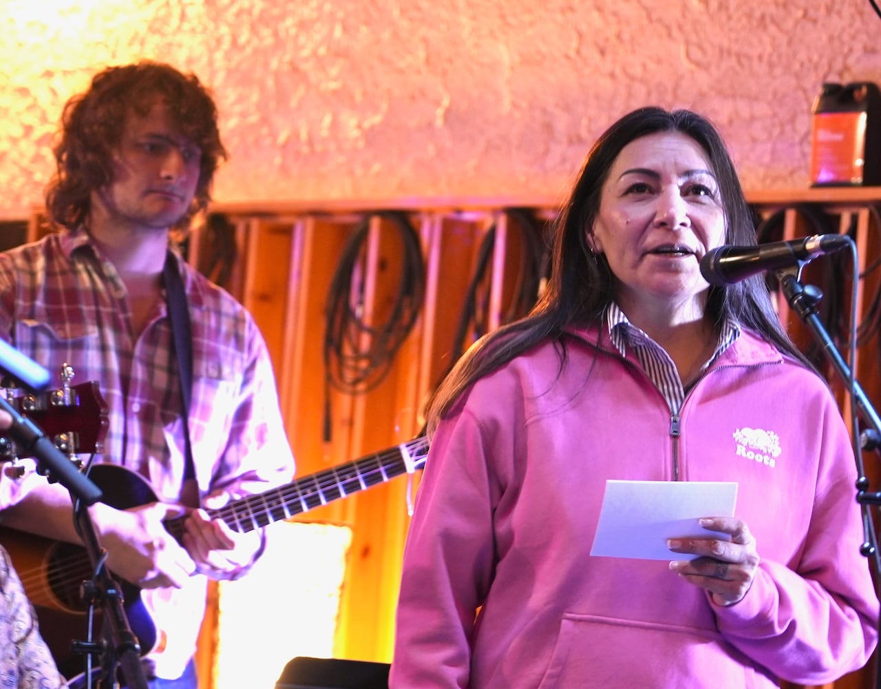 A woman is speaking on stage.