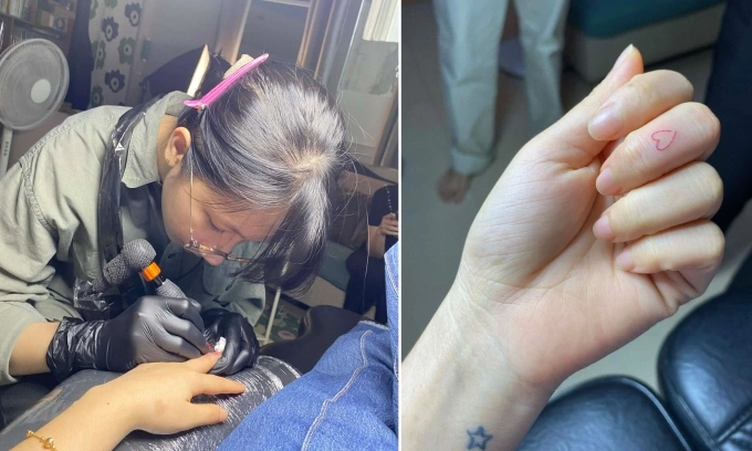 Truc An, from Ho Chi Minh City, has a tattooist mark her left hand and middle finger to help distinguish the directions. Photo by In